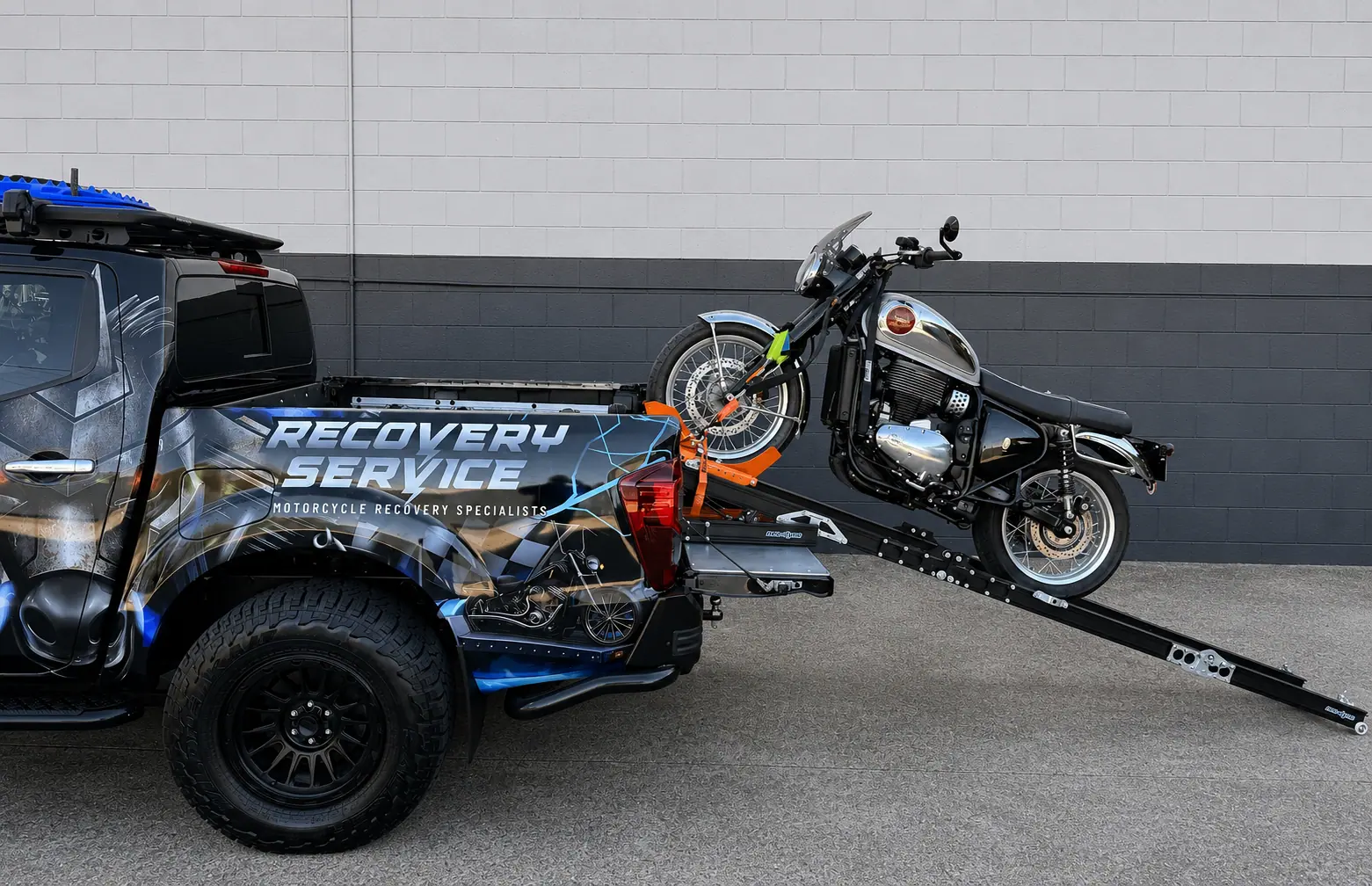 IRONHORSE recovery vehicle carrying a motorcycle